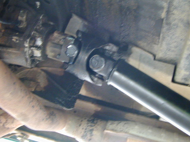 Close-up of a vehicle's driveshaft and U-joint assembly