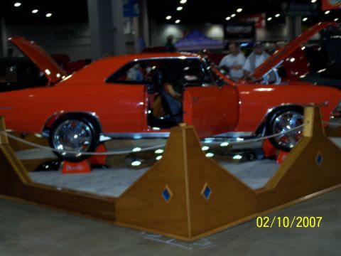 1979 Ford F-150 - Orange coupe with doors and hood open, on display at an indoor event.
