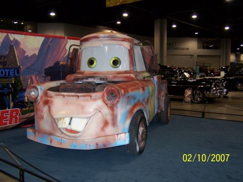 1979 Ford F-150 - This is a replica of the character Mater from the Disney/Pixar movie Cars, displayed at an indoor event.