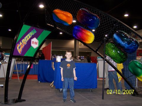 1979 Ford F-150 - A display of custom painted car parts, likely at a car show, with a young boy standing in front.