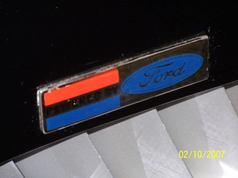 1979 Ford F-150 - Close-up of a Ford emblem with red and blue stripes, indicating a specific trim or package.
