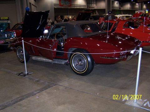 1979 Ford F-150 - A 1965 Chevrolet Corvette Sting Ray convertible is displayed indoors with its hood and door open.