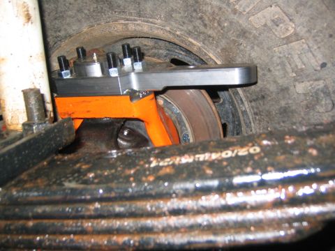 1979 Ford Bronco - New brake caliper bracket installed on a vehicle's front axle assembly.