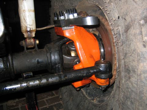 1979 Ford Bronco - Close-up view of a vehicle's front axle assembly, focusing on the knuckle and steering components.