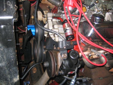 1979 Ford Bronco - Engine bay details with focus on the fan, belts, and power steering pump assembly.