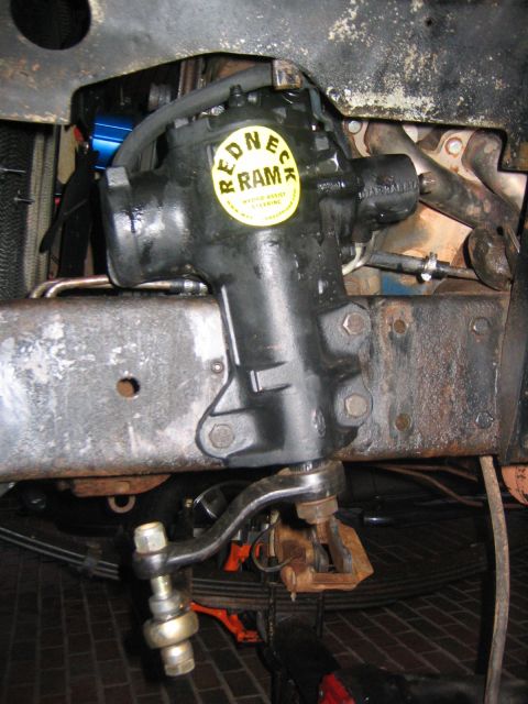 1979 Ford Bronco - Close-up of a steering box with a "REDNECK RAM" sticker, likely part of a front axle rebuild.