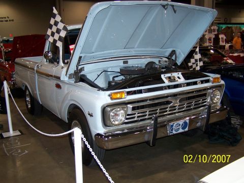 1979 Ford F-150 - A light blue Ford pickup truck is displayed with its hood open, checkered flags and a visible date stamp.