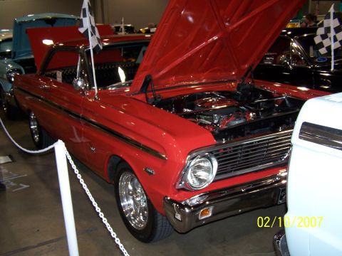 1979 Ford F-150 - A red classic car is displayed with its hood up, revealing the engine compartment.