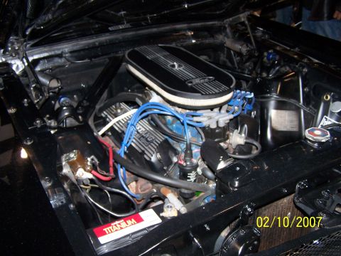 1979 Ford F-150 - Close-up of a V8 engine bay, an air cleaner labeled 'Mustang by Ford'.