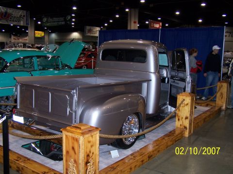 1979 Ford F-150 - Customized pickup truck on display indoors, with another classic car nearby.