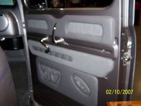 1979 Ford F-150 - Close-up of a custom interior door panel a chrome handle and an embossed "Ford" emblem, dated 02/10/2007.