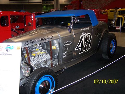 1979 Ford F-150 - Custom hot rod with exposed engine and 'Since 48' graphics, seen at an indoor car show.