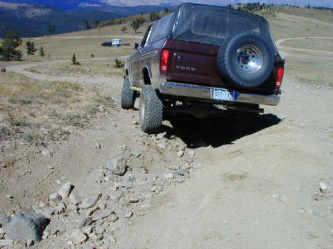 1979 Ford Bronco - This 1979 Ford Bronco is navigating a rocky off-road trail under a clear sky.