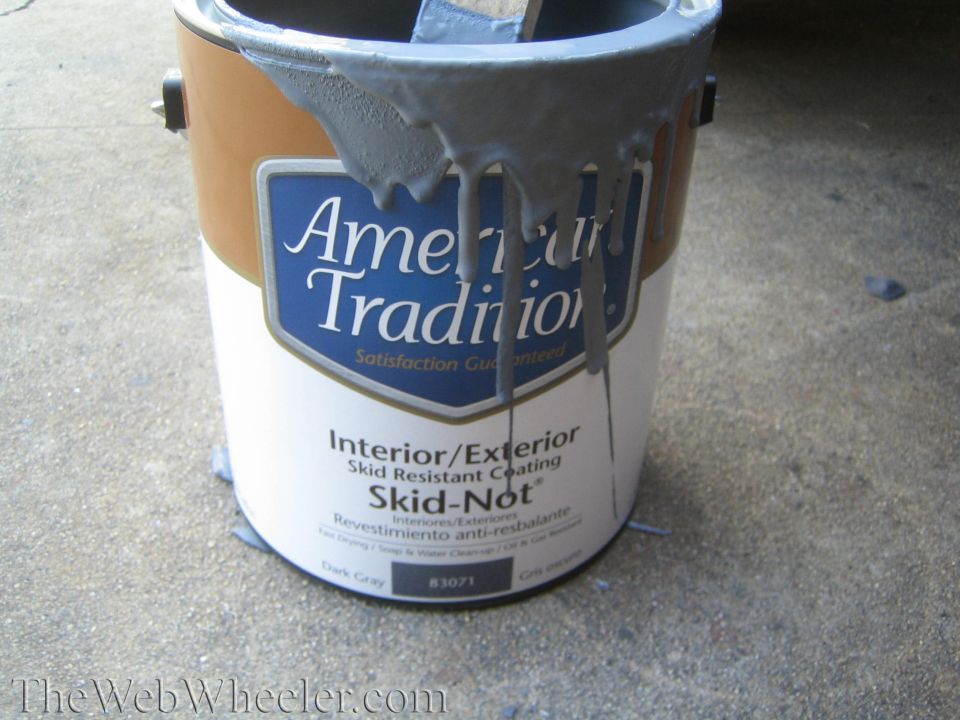 Paint can with gray paint dripping over label