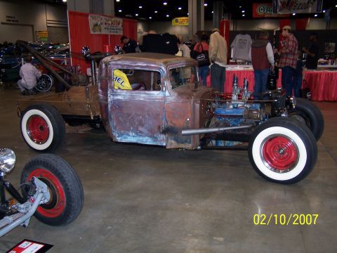 1979 Ford F-150 - Custom hot rod truck with a raw metal finish and whitewall tires on display indoors.