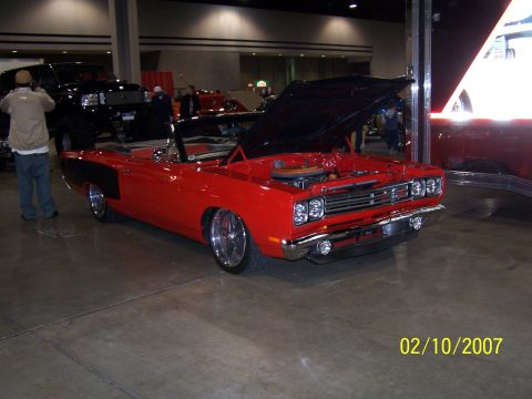 1979 Ford F-150 - Red 1969 Plymouth Road Runner convertible on display, hood open, showing engine bay.