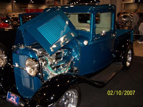 1979 Ford F-150 - Custom hot rod pickup truck displayed indoors with hood open, revealing the engine.