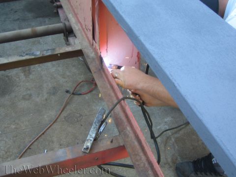 1987 Suzuki Samurai - Welding a section of a metal frame, with sparks flying.