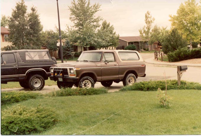 Brown 1978 Ford Bronco parked next to a black SUV