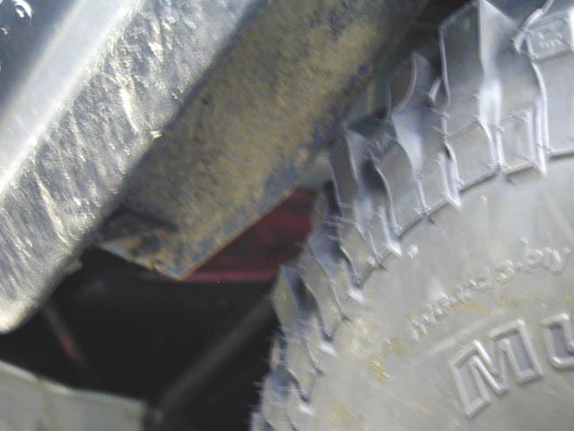 Close-up of a tire and fender with visible text on the tire