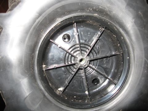 1990 Ford Bronco - Interior view of a wheel hubcap, showing the central mechanism and retaining clips.