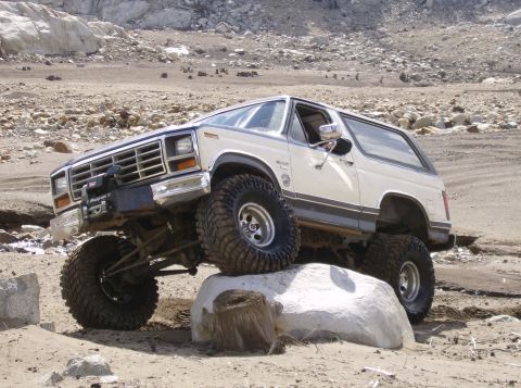 1986 Ford Bronco - Modified 1986 Ford Bronco navigating a rocky obstacle course.