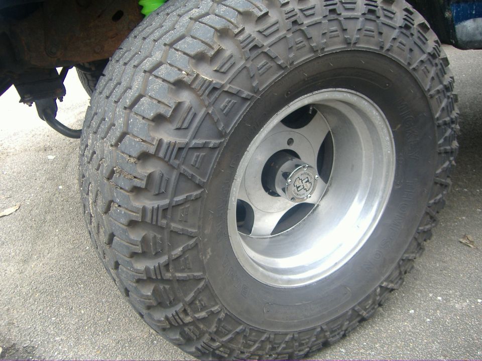 Mickey Thompson off-road tire on polished aluminum wheel with locking hub on a 4x4 truck