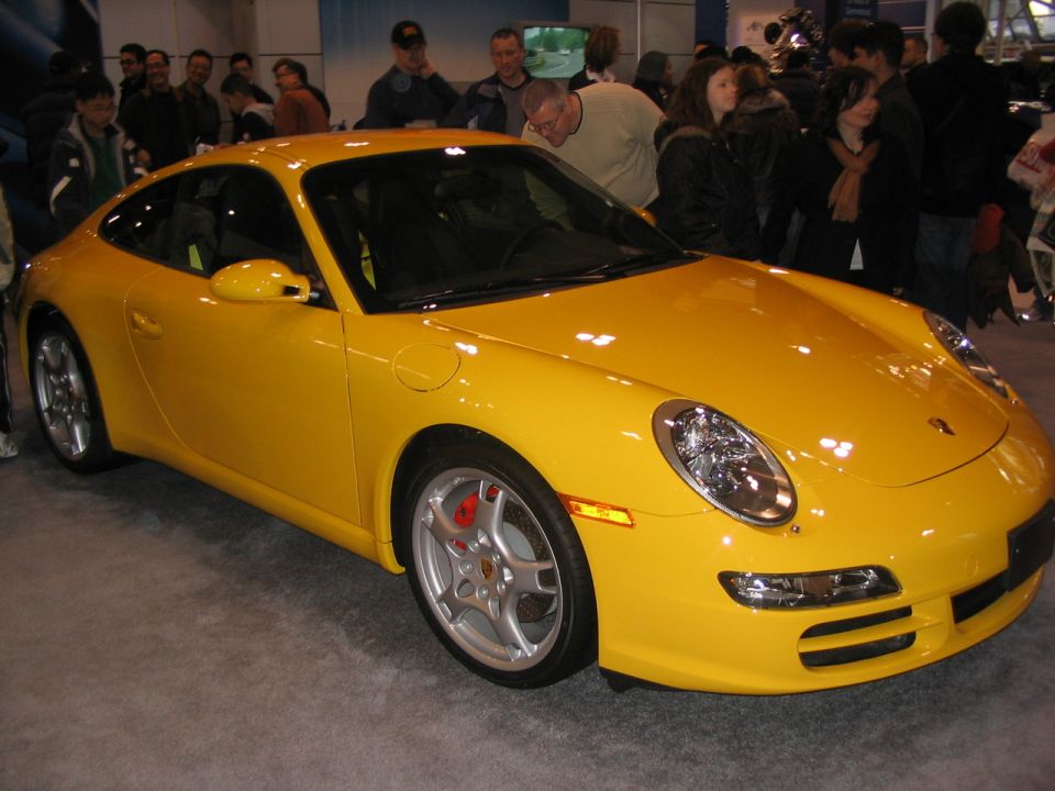 Yellow Porsche 911 front 3/4 view at auto show