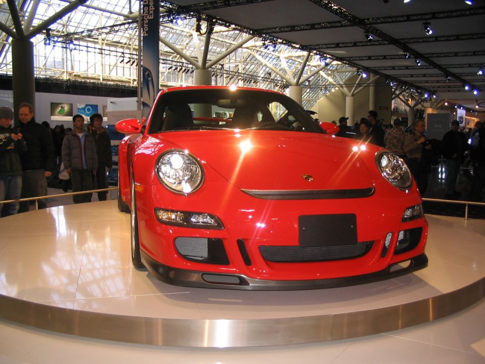 Red Porsche 911 on display at an auto show