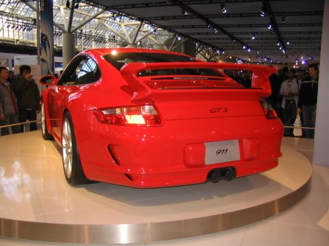 1993 Ford Taurus - Rear view of a red Porsche 911 GT3 on display at an auto show.