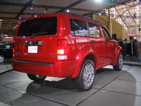 1993 Ford Taurus - Red Dodge Nitro SUV on display at an auto show.