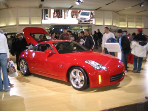 1993 Ford Taurus - Red Nissan 350Z on display at an auto show, likely the Toronto International Auto Show 2007.