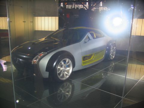 1993 Ford Taurus - Concept car displayed indoors with reflective flooring and bright lighting.