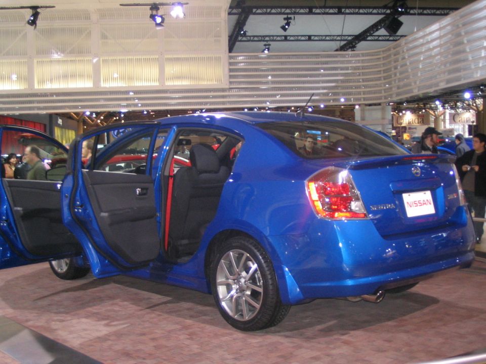 Blue Nissan Sentra rear quarter view with doors open