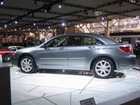 1993 Ford Taurus - A silver sedan is displayed indoors, with another vehicle partially visible on the left side.