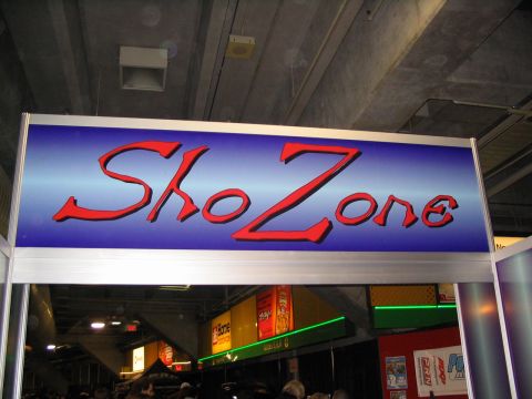 1993 Ford Taurus - Signage for SkoZone at an indoor event, possibly an auto show or convention.