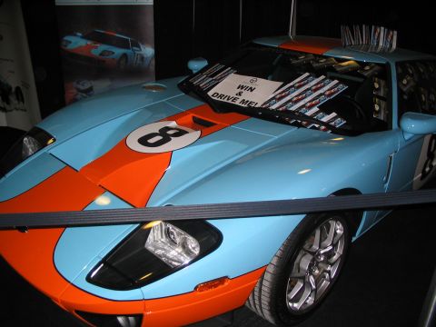 1993 Ford Taurus - A light blue and orange Ford GT40 replica, marked with the number 8, is displayed at an auto show.