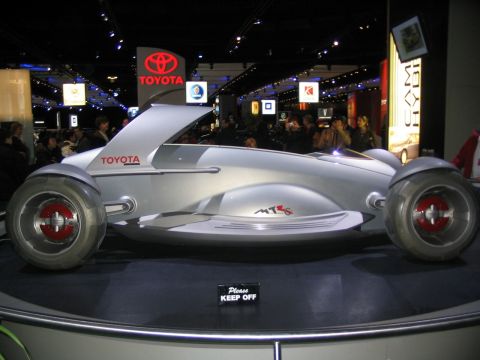 1993 Ford Taurus - Toyota concept car on display at an auto show, with a 'Please Keep Off' sign.