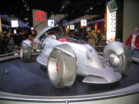 1993 Ford Taurus - A unique concept car is displayed at an auto show with a Toyota logo visible in the background.