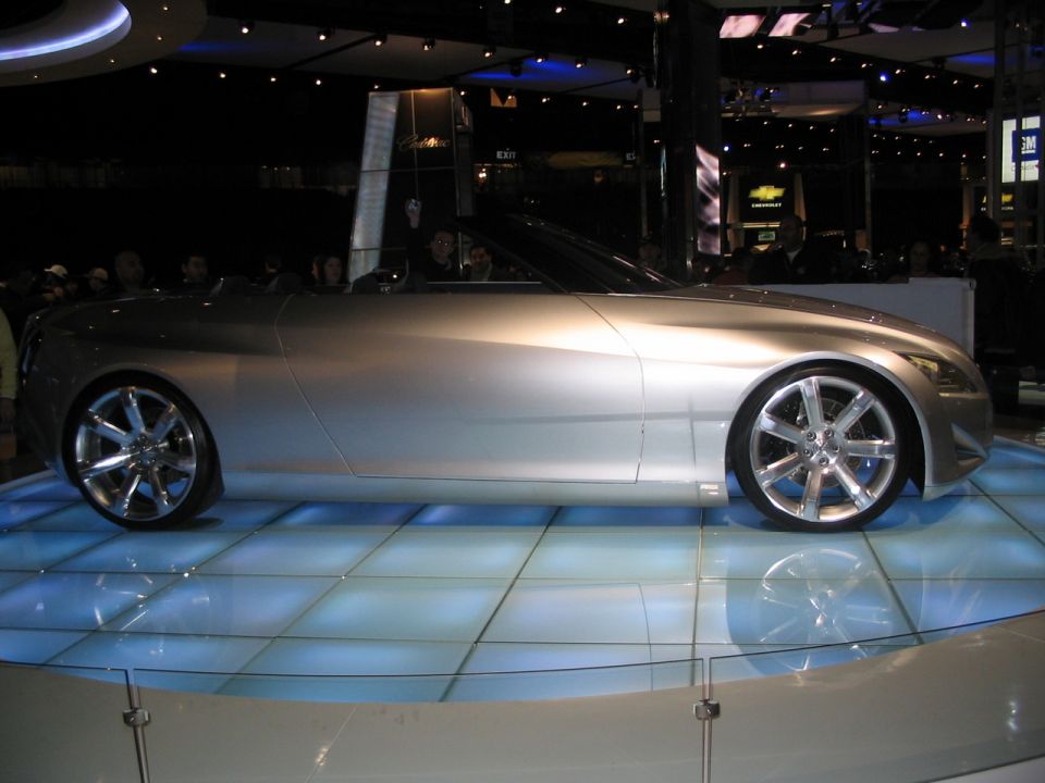 Silver convertible concept car on display at an auto show