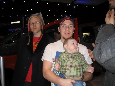 1993 Ford Taurus - Attendees pose for a photo at the Toronto International Auto Show in 2007, with a red vehicle and a "HUMMER" sign visible.