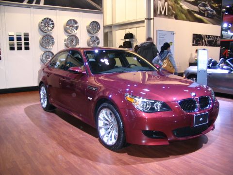 1993 Ford Taurus - A red BMW M5 sedan is displayed at the Toronto International Auto Show in 2007.