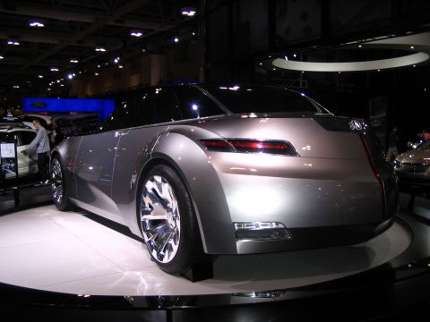 1993 Ford Taurus - A futuristic concept car is displayed at an auto show, its unique rear design and profile.