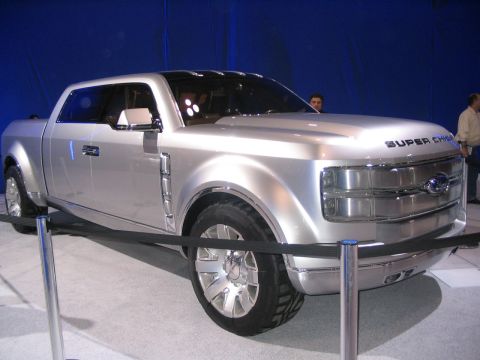 1993 Ford Taurus - A silver concept truck, identified as the Ford Super Chief, is displayed indoors with a blue backdrop.