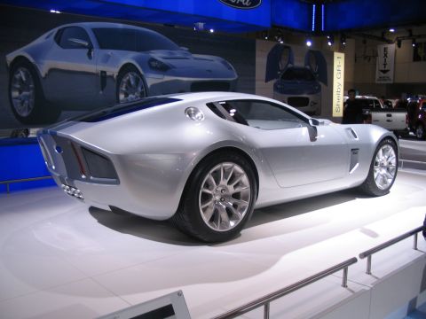 1993 Ford Taurus - Shelby GR-1 concept car displayed at an auto show, with a Ford logo visible overhead.