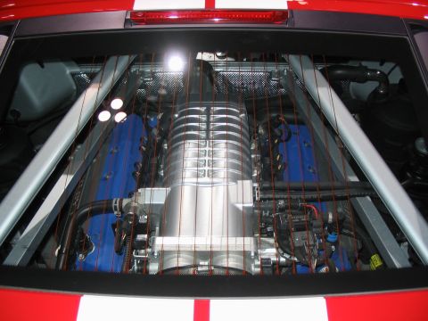 1993 Ford Taurus - Close-up of a supercharged V8 engine, likely from a performance car, seen through the rear window.