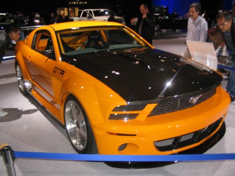 1993 Ford Taurus - Customized Ford Mustang with GTR badging displayed at an auto show.