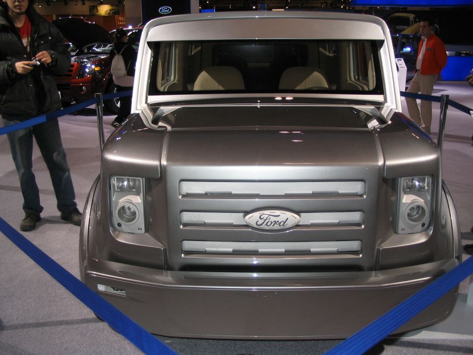 Silver Ford concept van front view with horizontal grille and large headlights