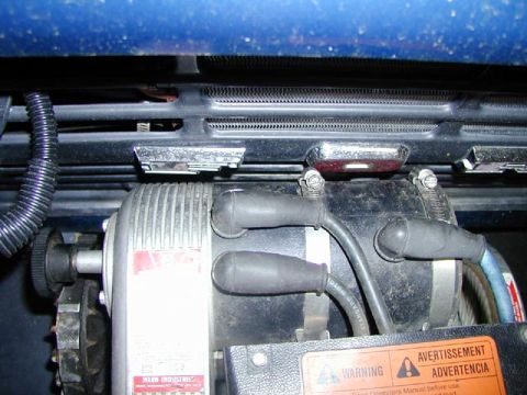 1979 Ford Bronco - Detail of an engine part, possibly an ignition coil, with visible wiring and manufacturer labels.