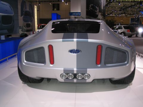 1993 Ford Taurus - Silver Ford concept car with racing stripes and quad exhaust pipes on display.